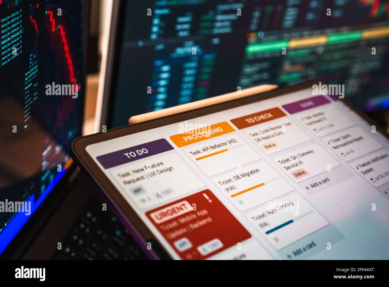 Office Interior, Desktop computer and laptop screen displaying a software development kanban board interface with task cards like "To Do", "Processing Stock Photo