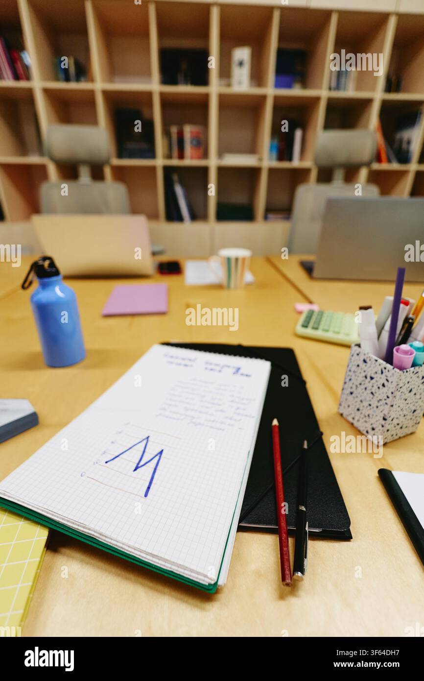 Notebook with Financial Chart on Desk in Empty Modern Office Stock Photo