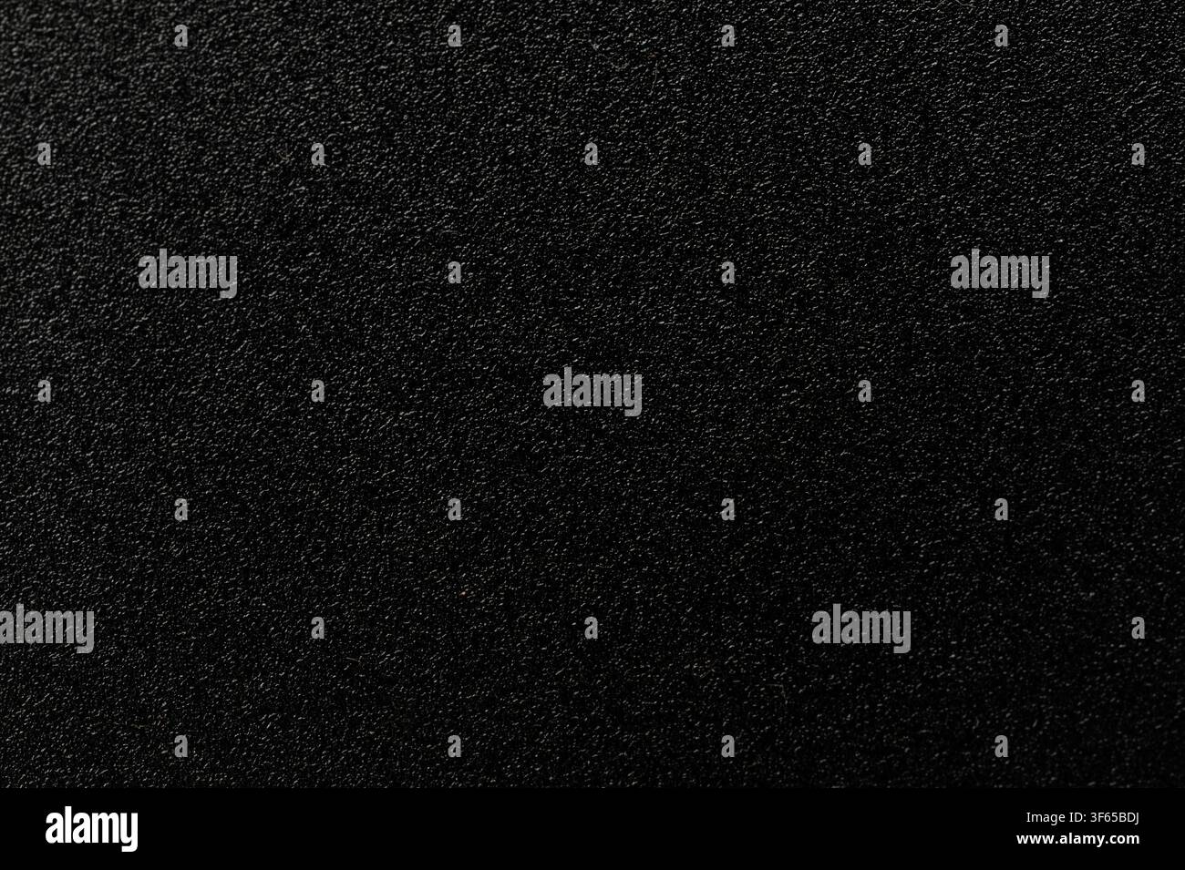 Rough black industrial plastic material surface macro close up view Stock Photo