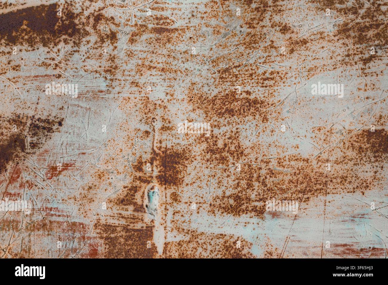 Industrial grunge background texture of heavily rusted metal surface with scratched old paint and brown corrosion spots. Stock Photo