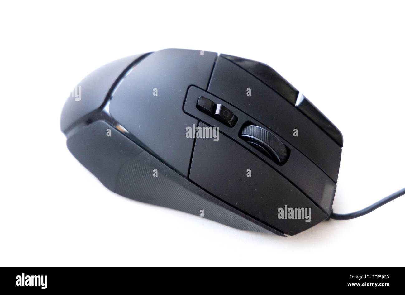 A modern black wired computer mouse sits angled against a clean white background Stock Photo