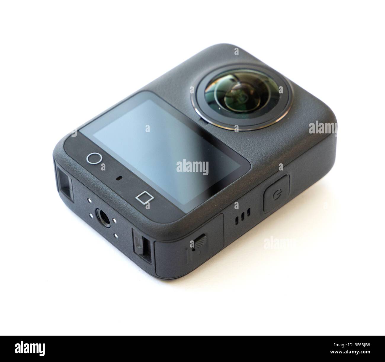 A compact black action camera with a prominent fisheye lens is positioned at an angle on a clean white surface Stock Photo