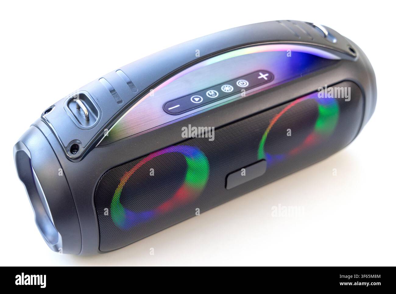 A modern black wireless portable bluetooth speaker featuring colorful LED lighting is displayed on a white background Stock Photo