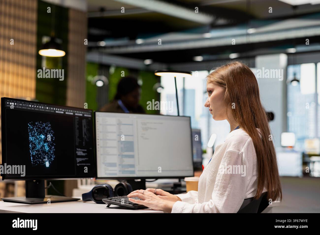 Junior dev using AI LLM chatbot, optimizing company systems performance. Intern using artificial intelligence assistant to convert manual workflows into automated scripts Stock Photo