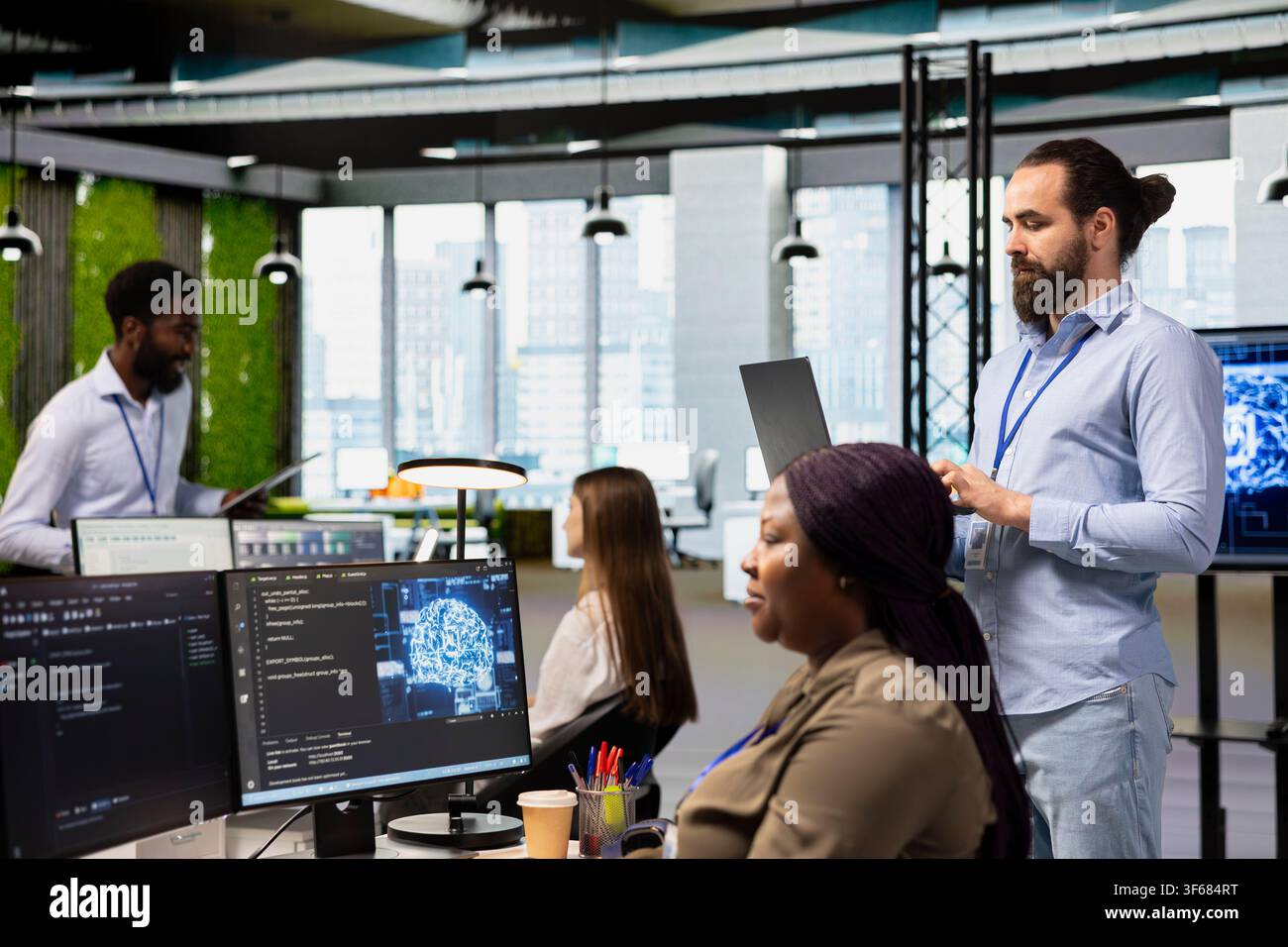 Teamworking engineers writing code, developing machine learning APIs. Team of IT experts in office working together, troubleshooting software errors using artificial intelligence Stock Photo