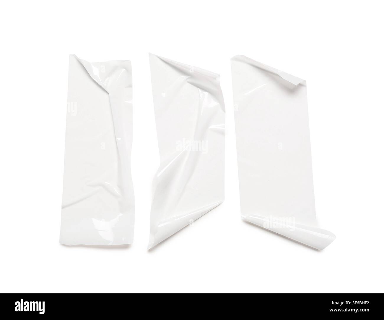 Three pieces of white adhesive tape with curled edges, isolated on a clean white background for design elements, the tape strips are ready for use in Stock Photo