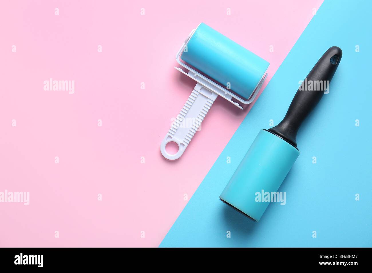 Different lint rollers on color background Stock Photo
