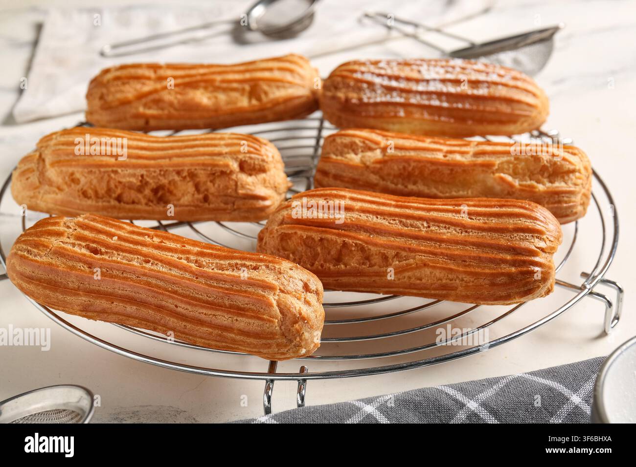Grid with tasty eclairs on marble background Stock Photo
