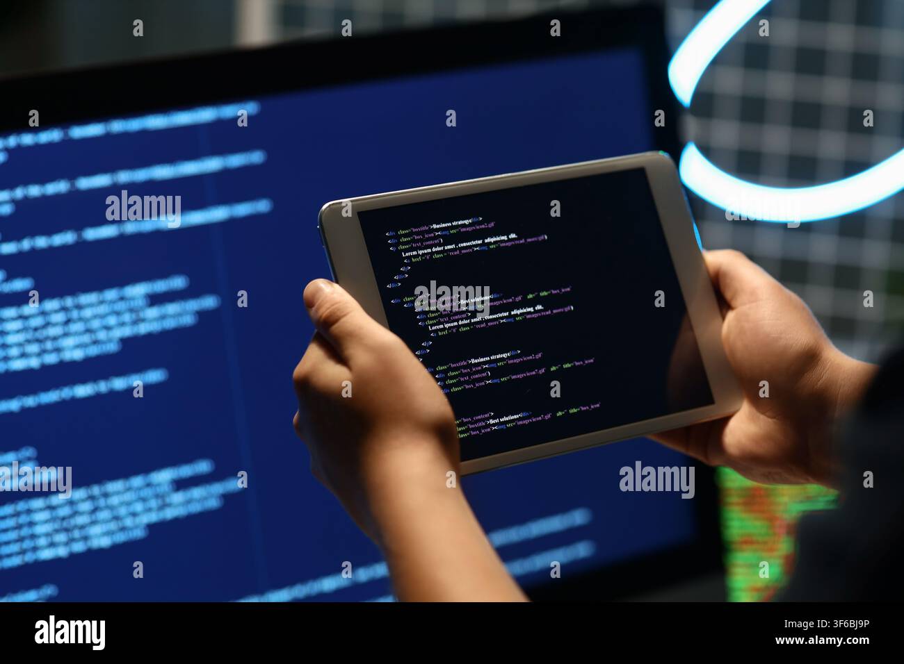 Programmers hands with modern tablet computer in office, closeup Stock Photo