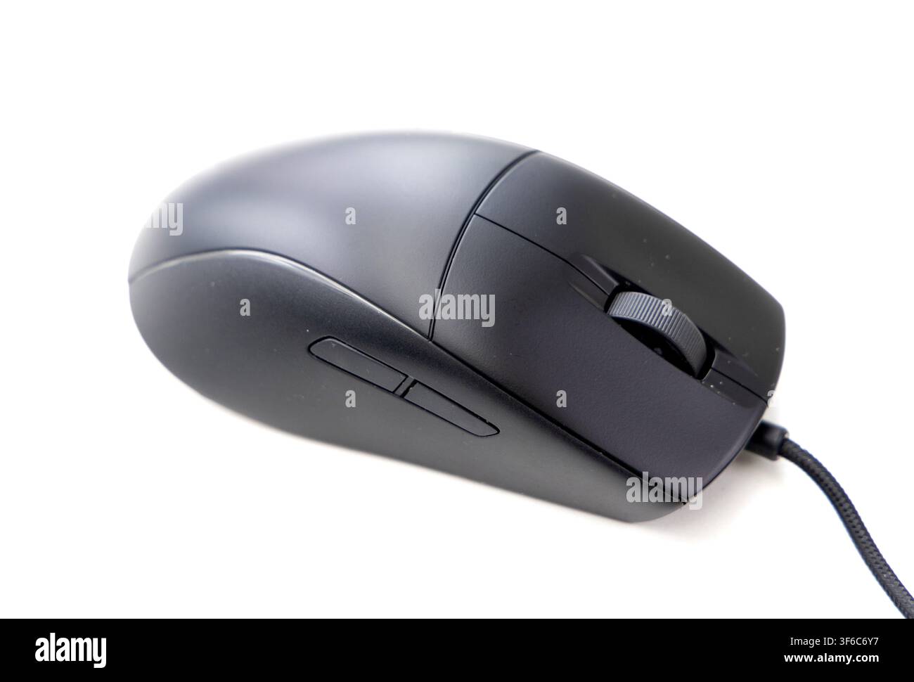 A modern black wired computer mouse rests against a stark white background Stock Photo