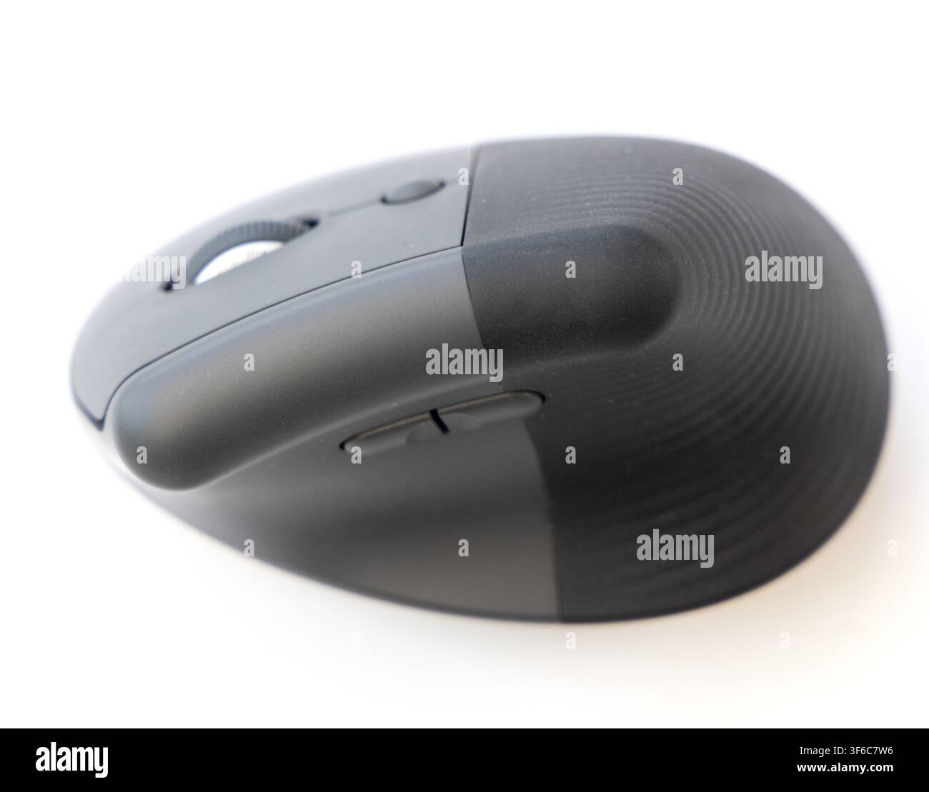 A closeup studio shot of a modern ergonomic computer mouse positioned on a clean white background Stock Photo