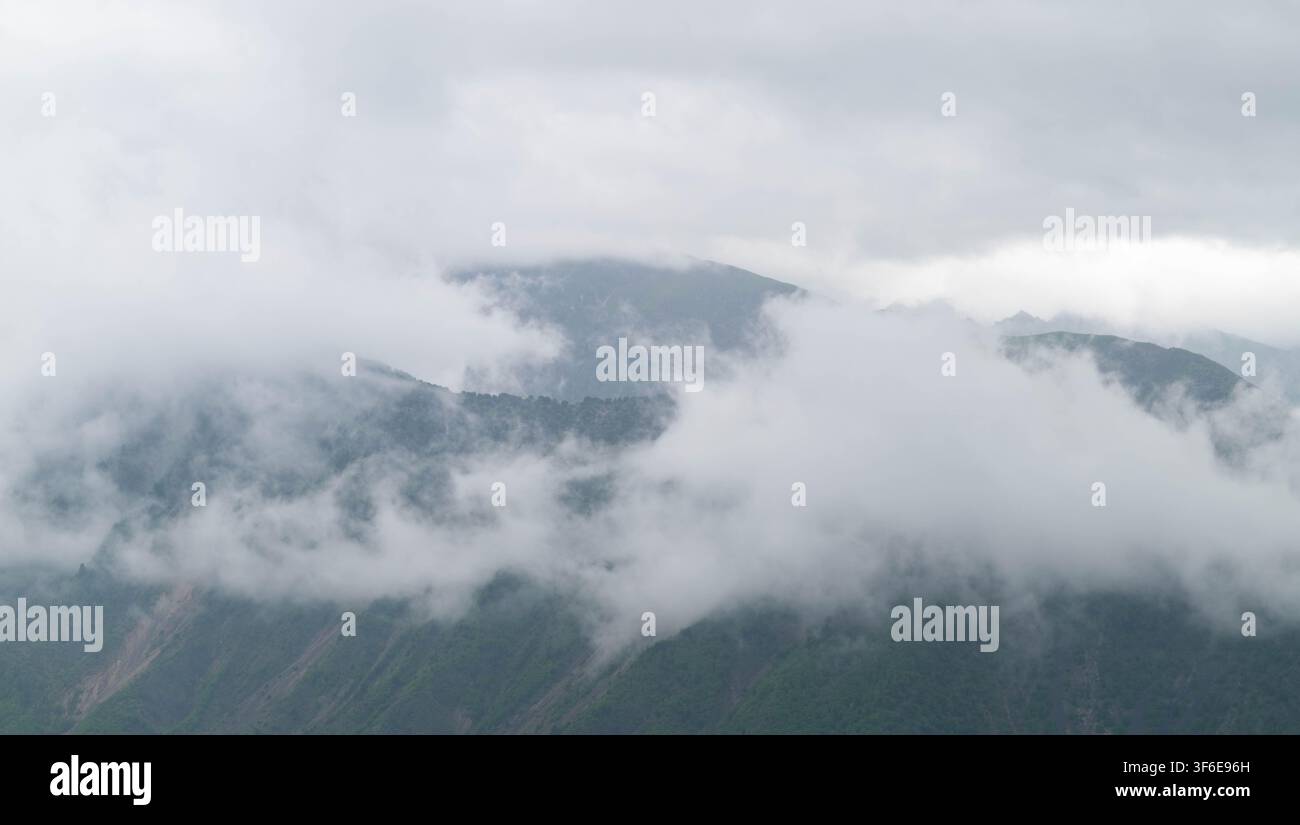 Big clouds covering the mountains. Stock Photo
