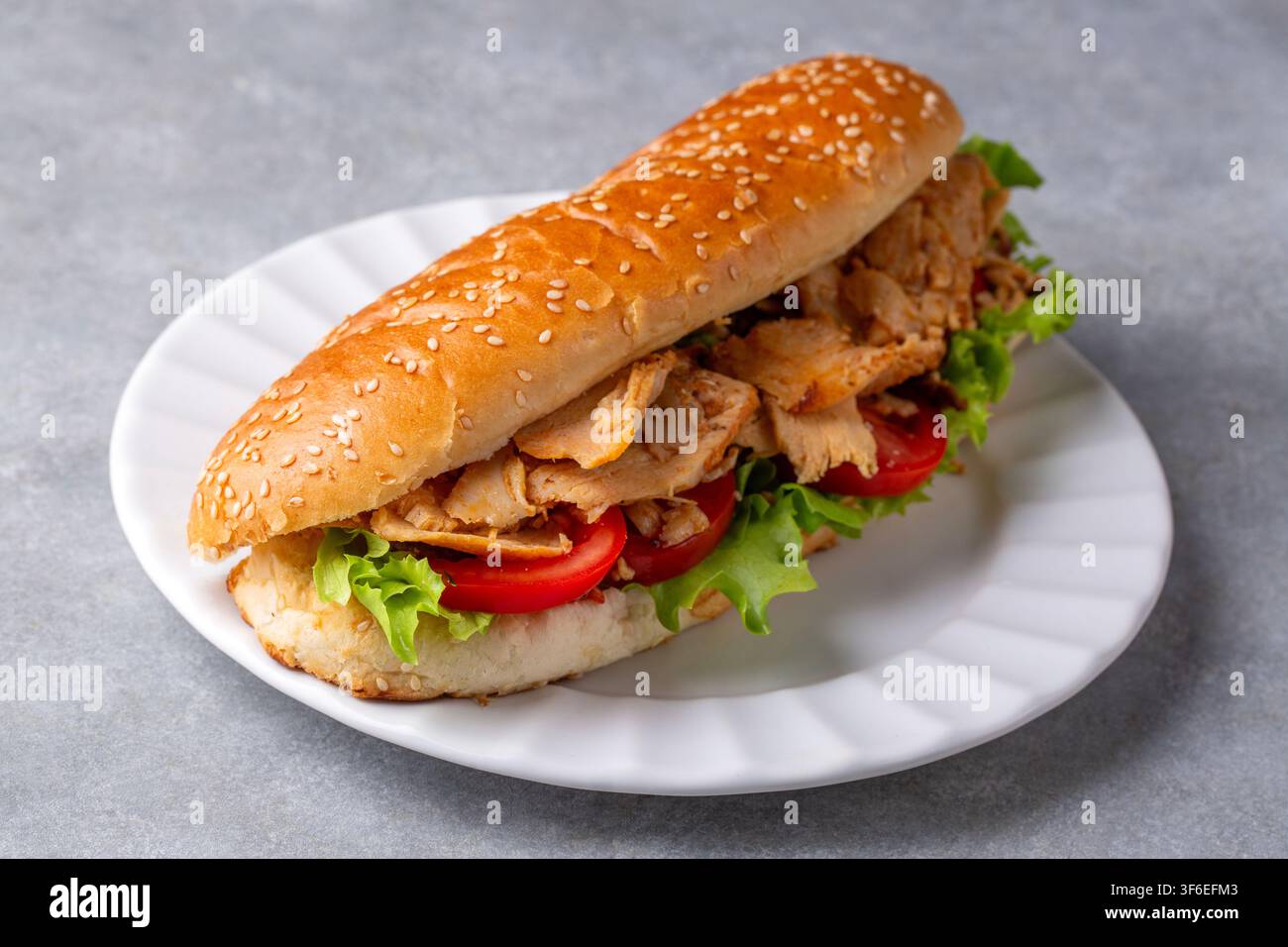 Turkish chicken doner kebab sandwich with fresh lettuce and tomatoes in a sesame bun Stock Photo