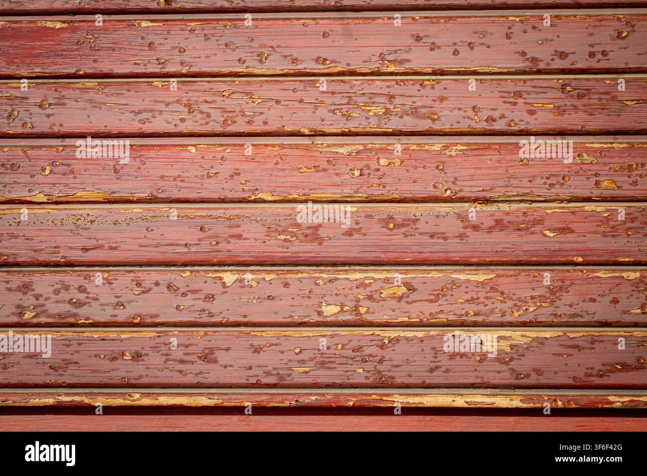 Weathered Red Barn Wood Backdrop with Flaking and Peeling Paint Texture Stock Photo
