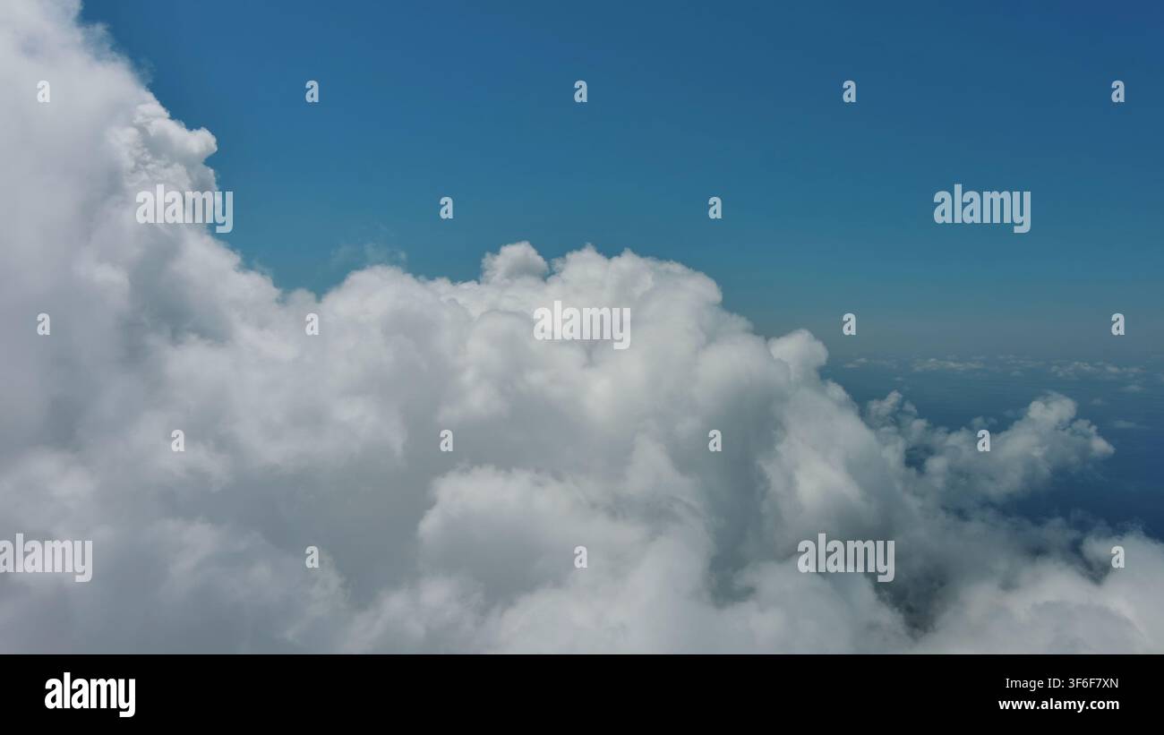 Flying through white fluffy clouds Stock Photo