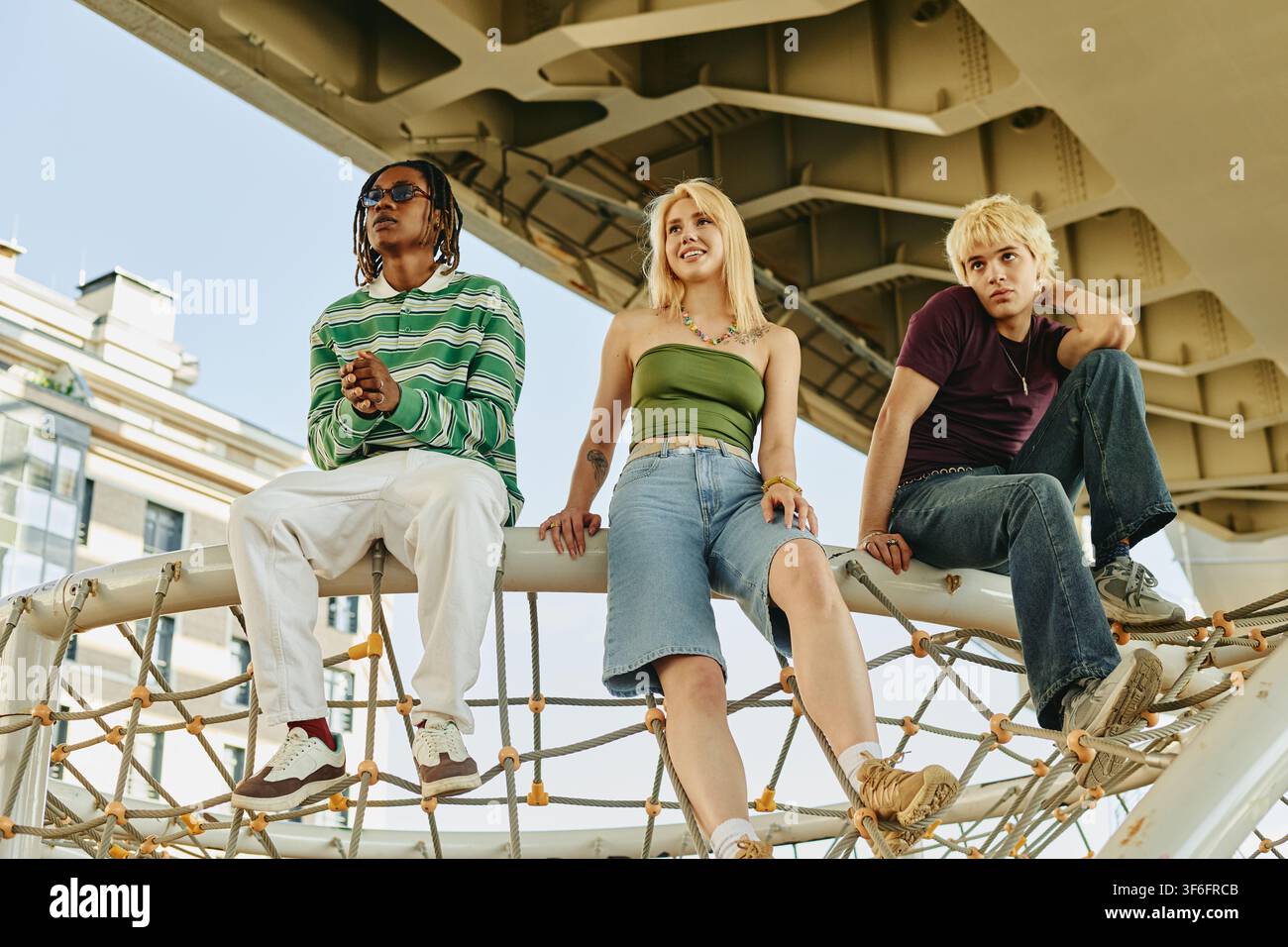 Diverse People Sitting Outdoors on Playground Structure Stock Photo