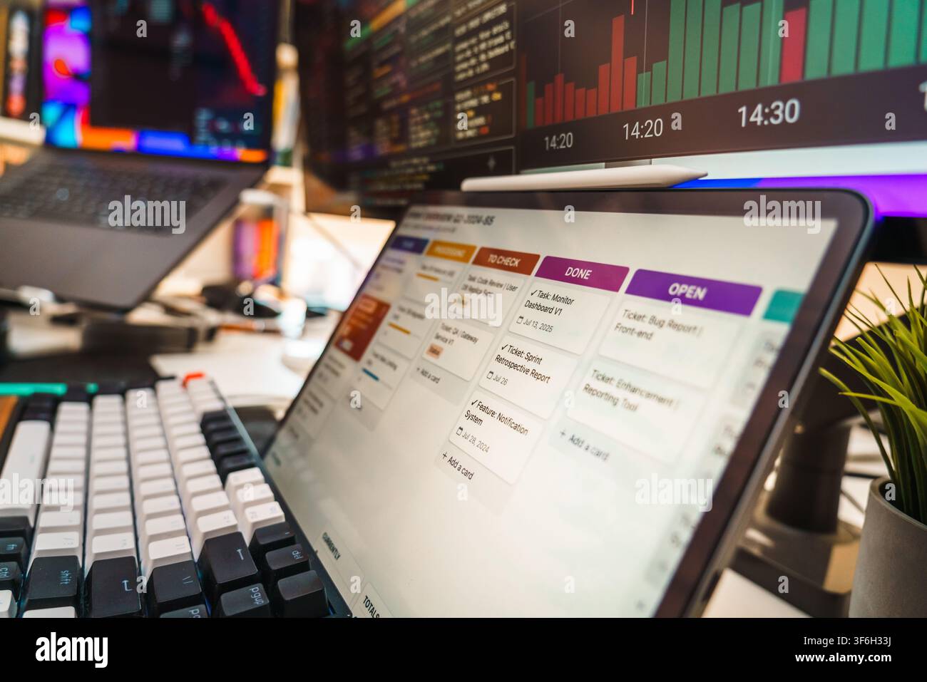 Software Engineer Development Workspace Task Management Screen Mechanical Keyboard. Close up view of a software developer workspace featuring a digita Stock Photo