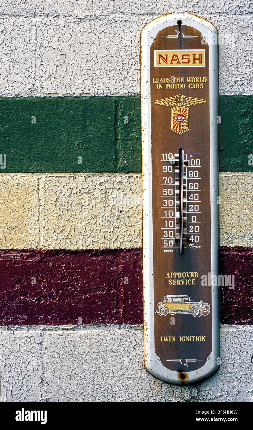 Antique Thermometer on cinder block wall Stock Photo