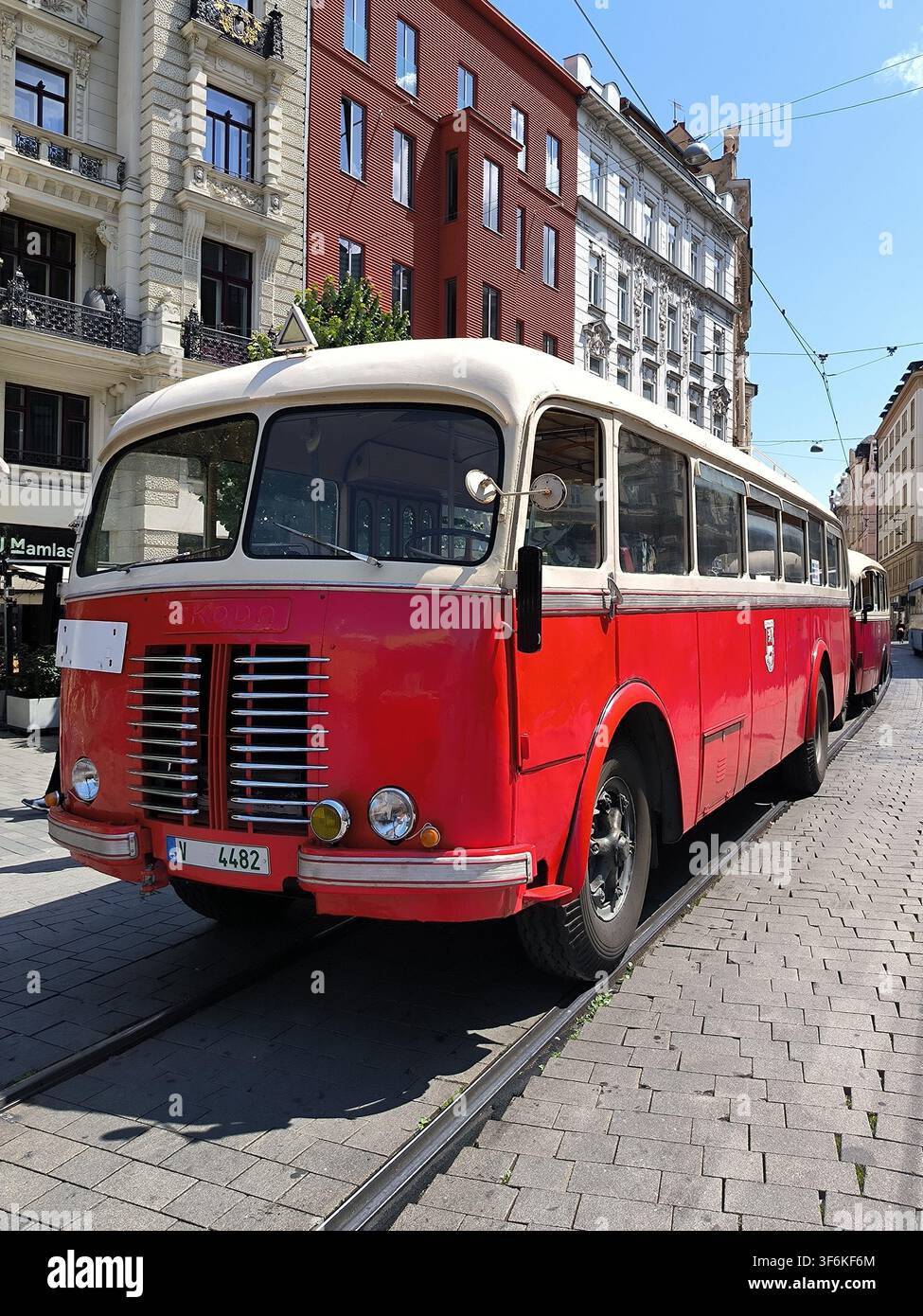 Brno, Czech Republic - June 17, 2023: Historical red and white vintage bus Skoda 706 RO on city street tracks during the Transport Nostalgia event. - Smartphone Captured Stock Image
