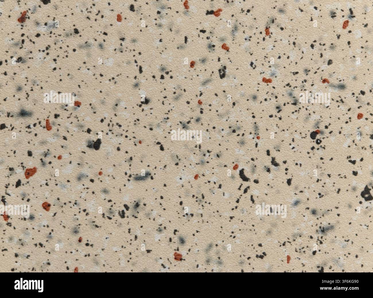 Beige composite material surface texture with black and terracotta flecks Stock Photo