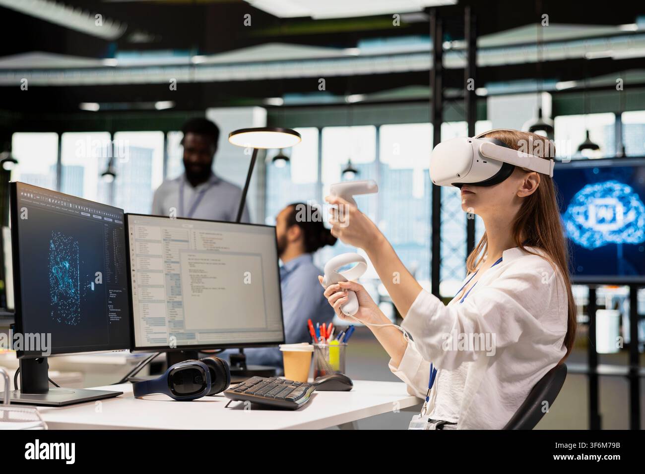 Junior programmer using virtual reality at work, testing generative AI machine learning algorithms. Young worker wearing VR goggles equipment scaling productivity with AI large language model code Stock Photo