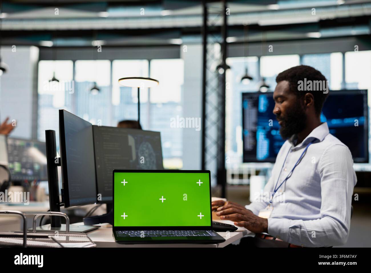 Engineer using isolated screen laptop, writing code, developing machine learning APIs. IT expert in office troubleshooting software errors using artificial intelligence tech on chroma key notebook Stock Photo