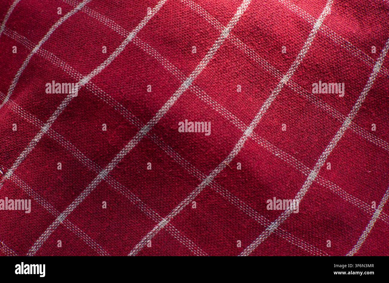 Red Checkered Fabric Texture Background With Diagonal Folds Stock Photo