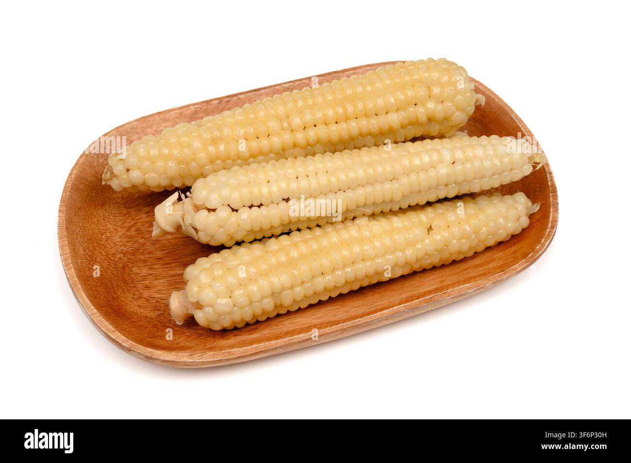 Steamed sweet corn cobs on a wooden tray Stock Photo