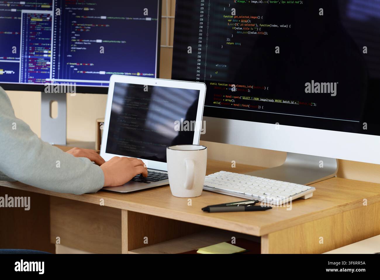 Female programmers hands testing code on laptop in office Stock Photo
