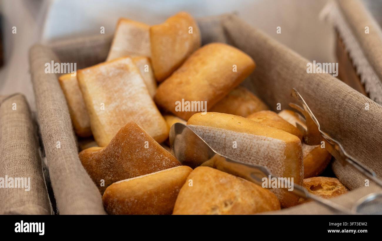 Fresh Bread Rolls in Basket at Hotel Breakfast Buffet Stock Photo