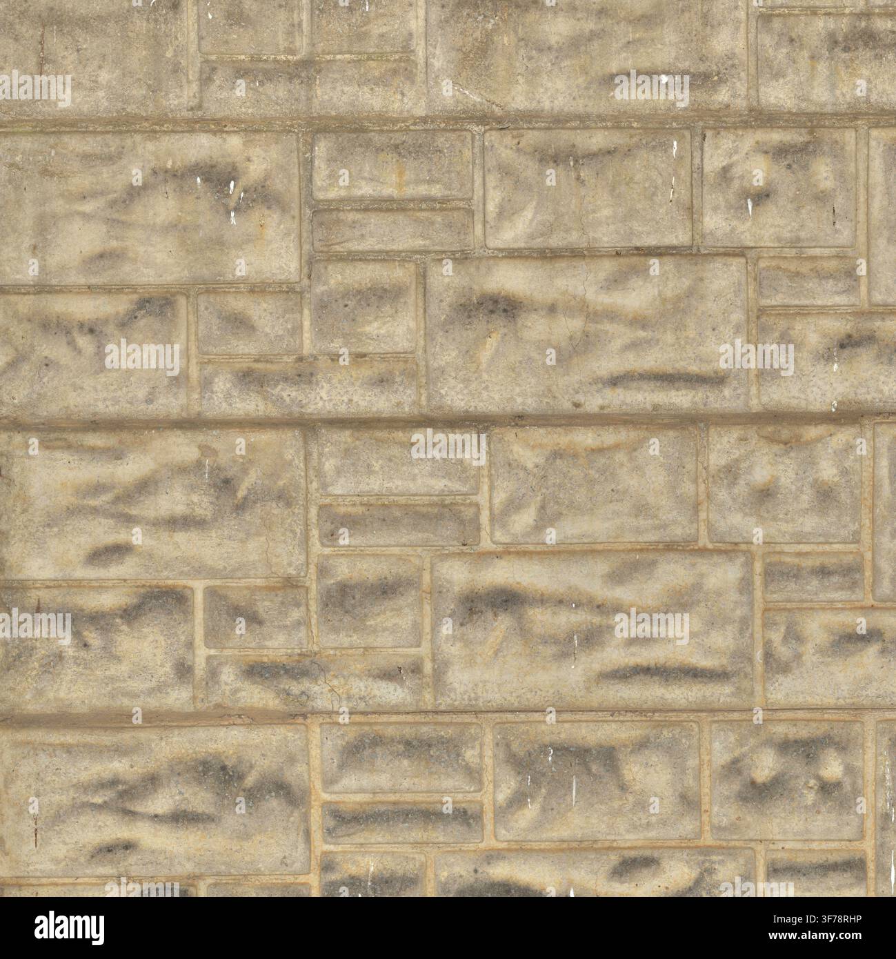 A light gray precast concrete wall surface molded with rectangular faux stone blocks. Stock Photo