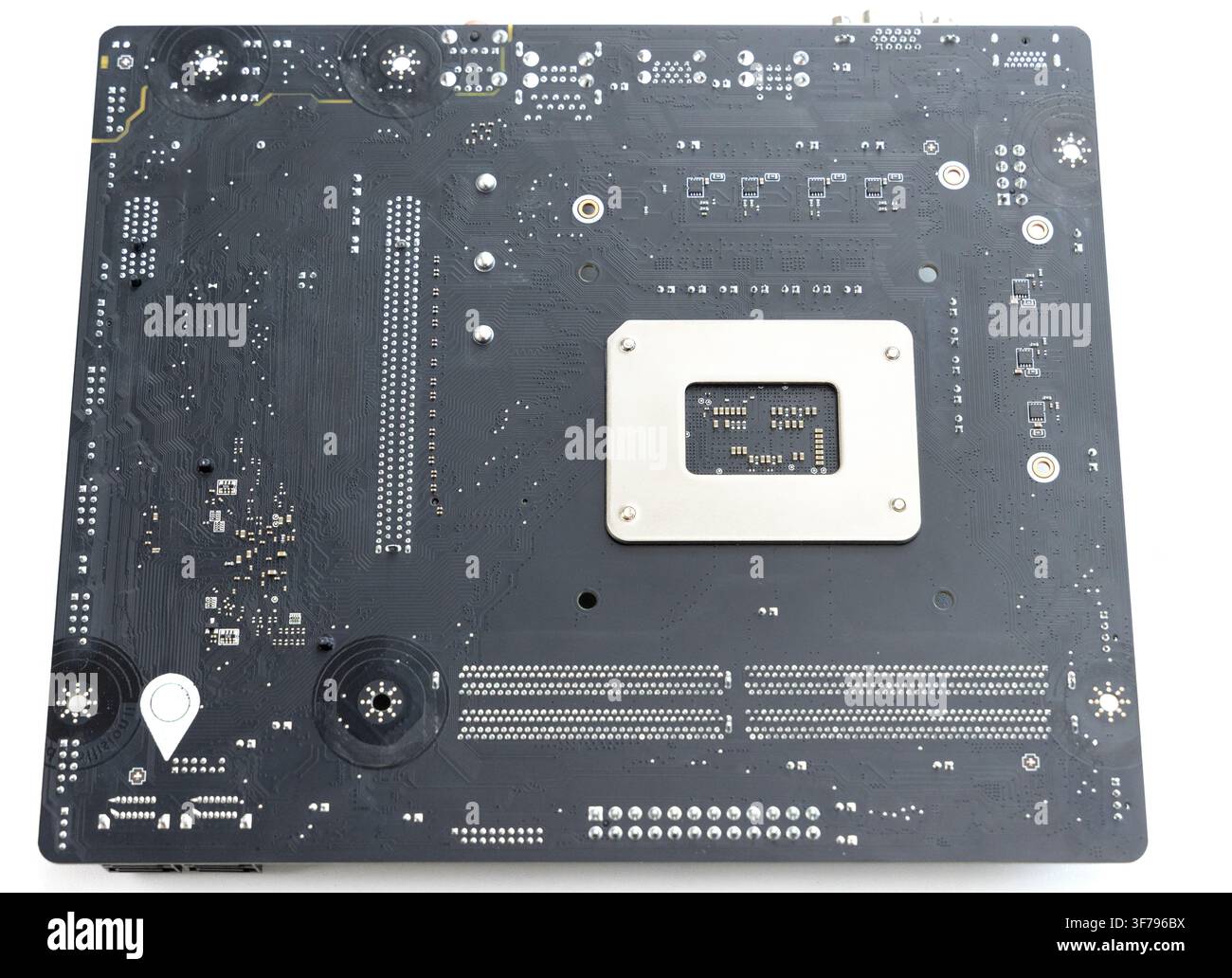 The back side of a black computer motherboard Stock Photo