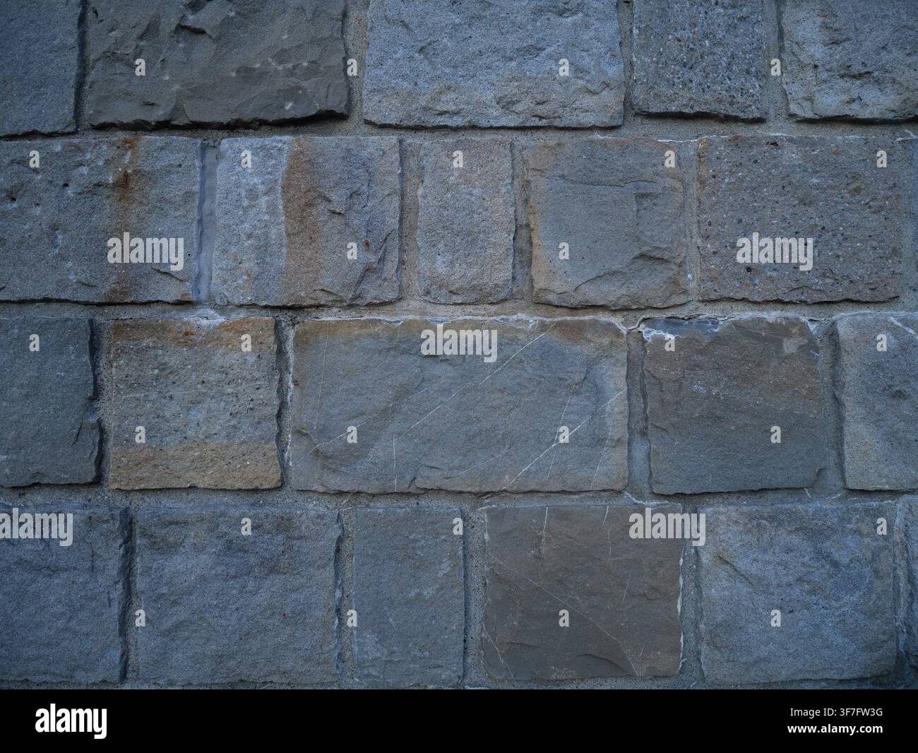 Large Grey Stone Block Wall Texture with Rough Weathered Surface, Rustic Masonry Background for Design and Architecture Projects. Stock Photo