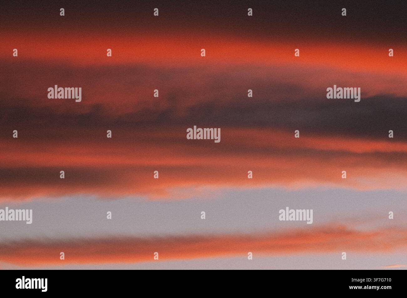 Fiery sunset clouds creating a vibrant evening sky Stock Photo