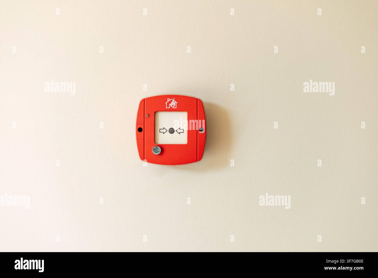 Red fire alarm button on wall Stock Photo