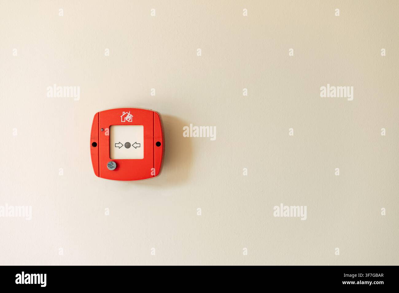 Red fire alarm button on wall Stock Photo