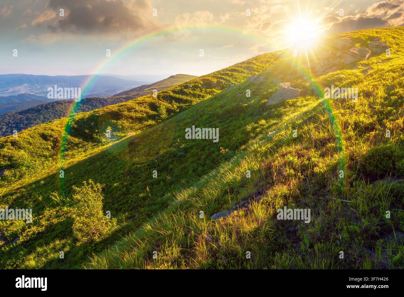 sunset over mountain landscape in summer. beautiful outdoor scenery of carpathian mountains. grassy slopes with rocks. image for ukraine travel backgr Stock Photo