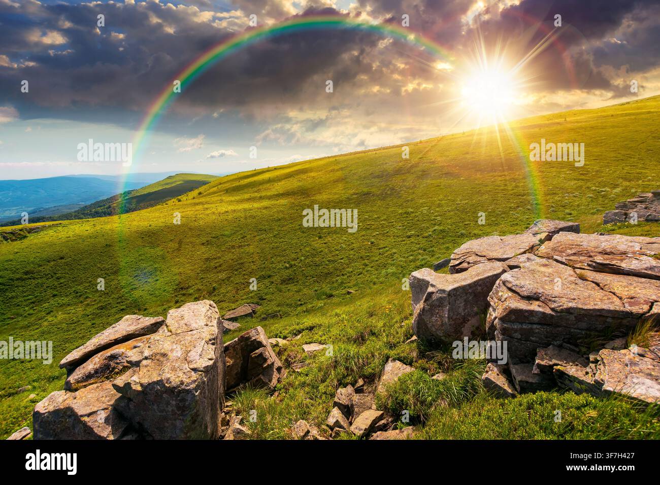 sunset over carpathian mountain landscape in summer. nice background for outdoor adventure in evening light. transcarpathia green hill with rocks Stock Photo
