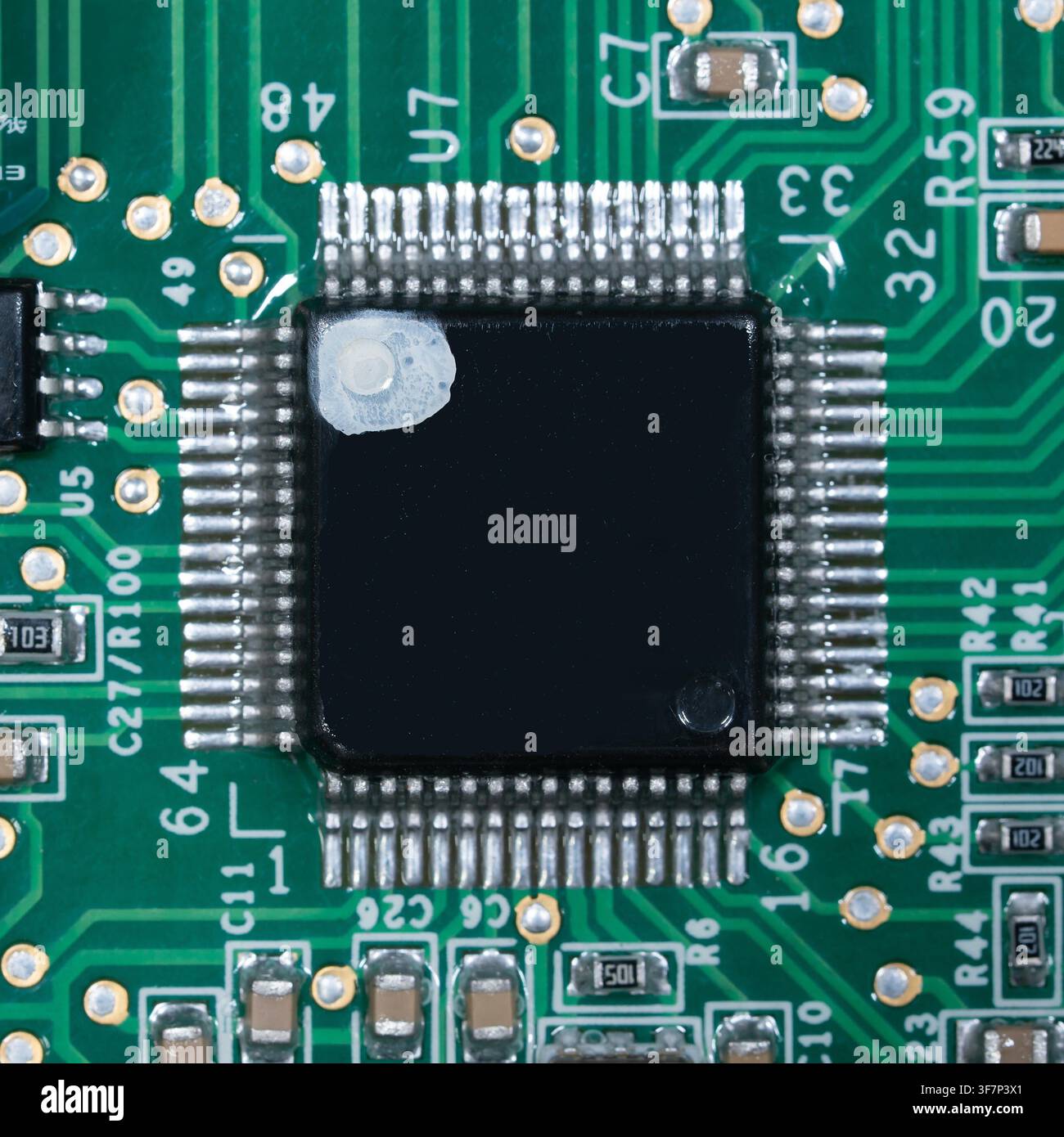 Macro of small microprocessor soldered printed circuit board. Stock Photo