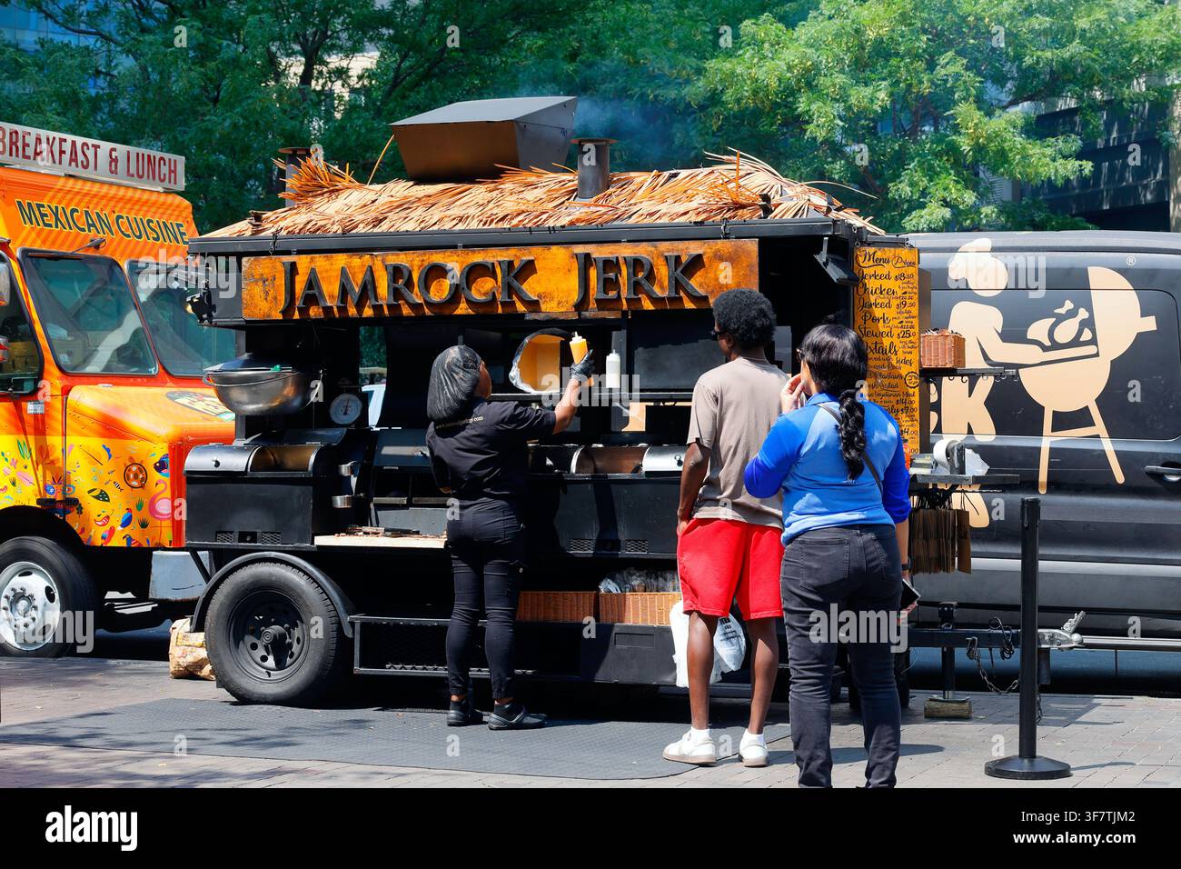A location of Jamrock Jerk fast casual street cart vendor of Jamaican barbeque jerk chicken at a location in New York City. Stock Photo