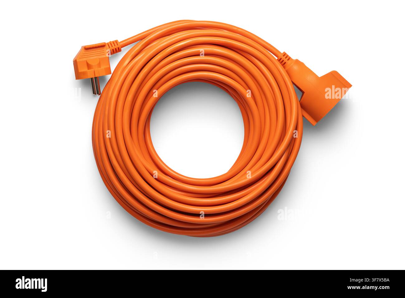 Coiled orange extension cord isolated on white background, top view Stock Photo