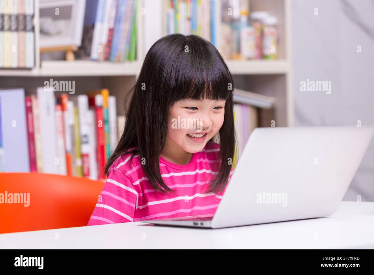 Joyful Asian Girl Student Typing on Laptop for Homework in Study Room ...