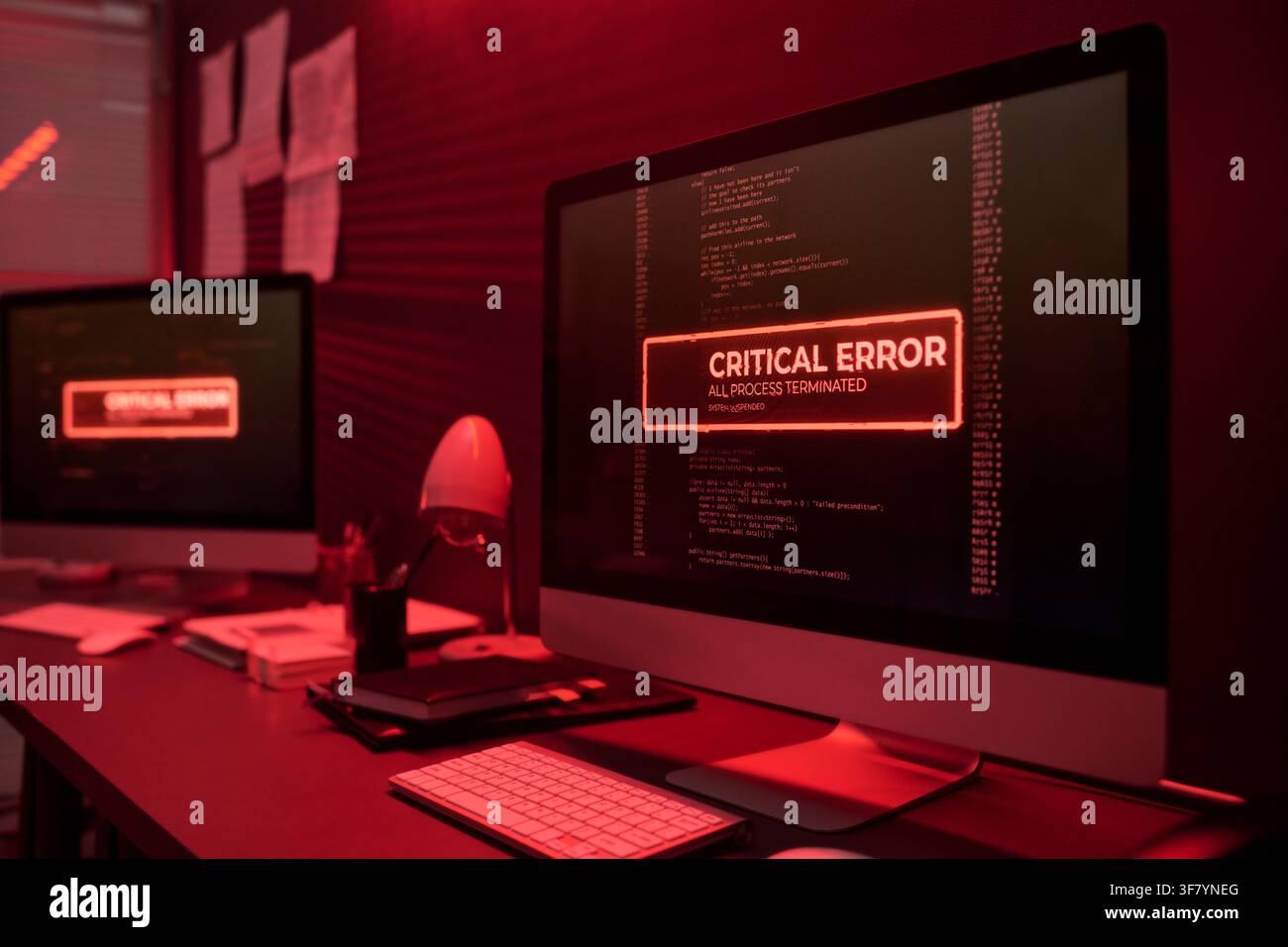 Computer Screen Displaying Critical Error Message in Dark Office Stock Photo