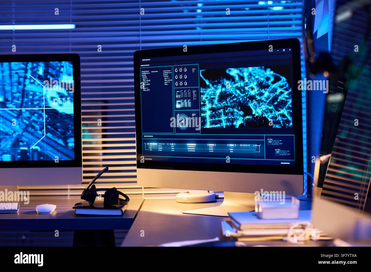 Computer Monitors Displaying Cyber Security Data in Modern Office Stock Photo