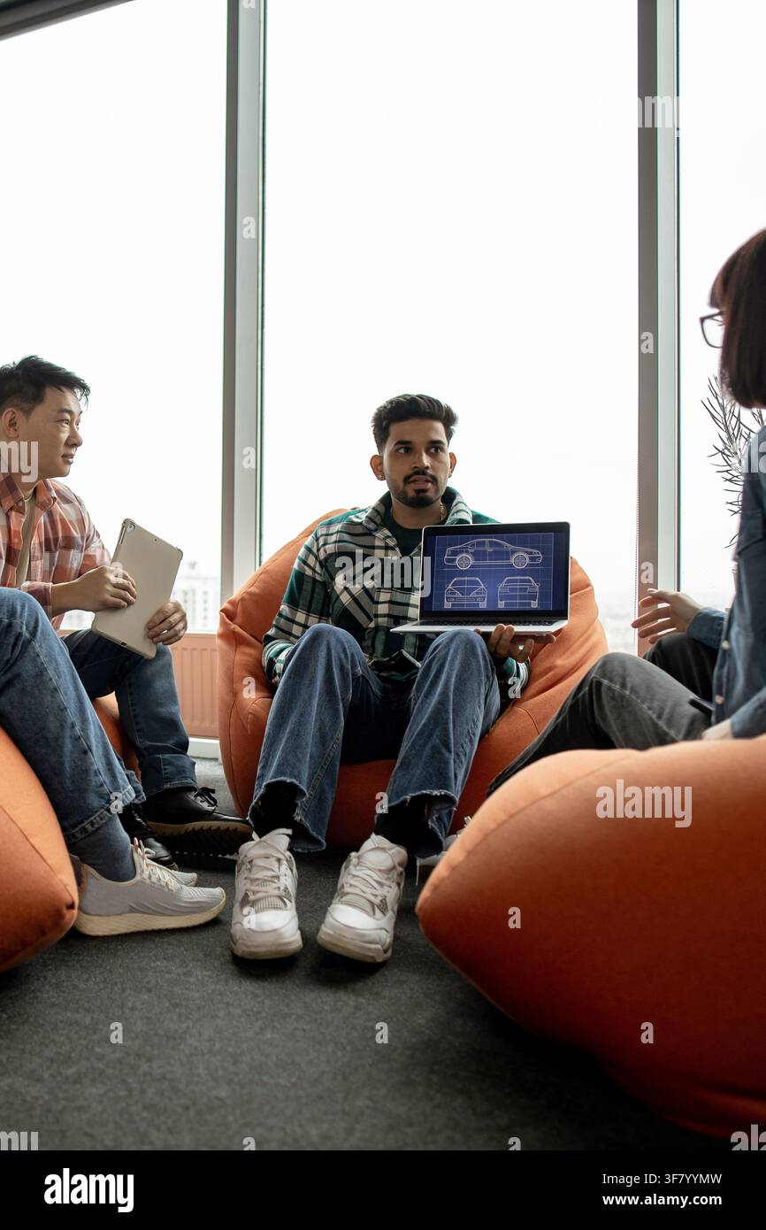 Team Discussing Car Design Blueprint Stock Photo