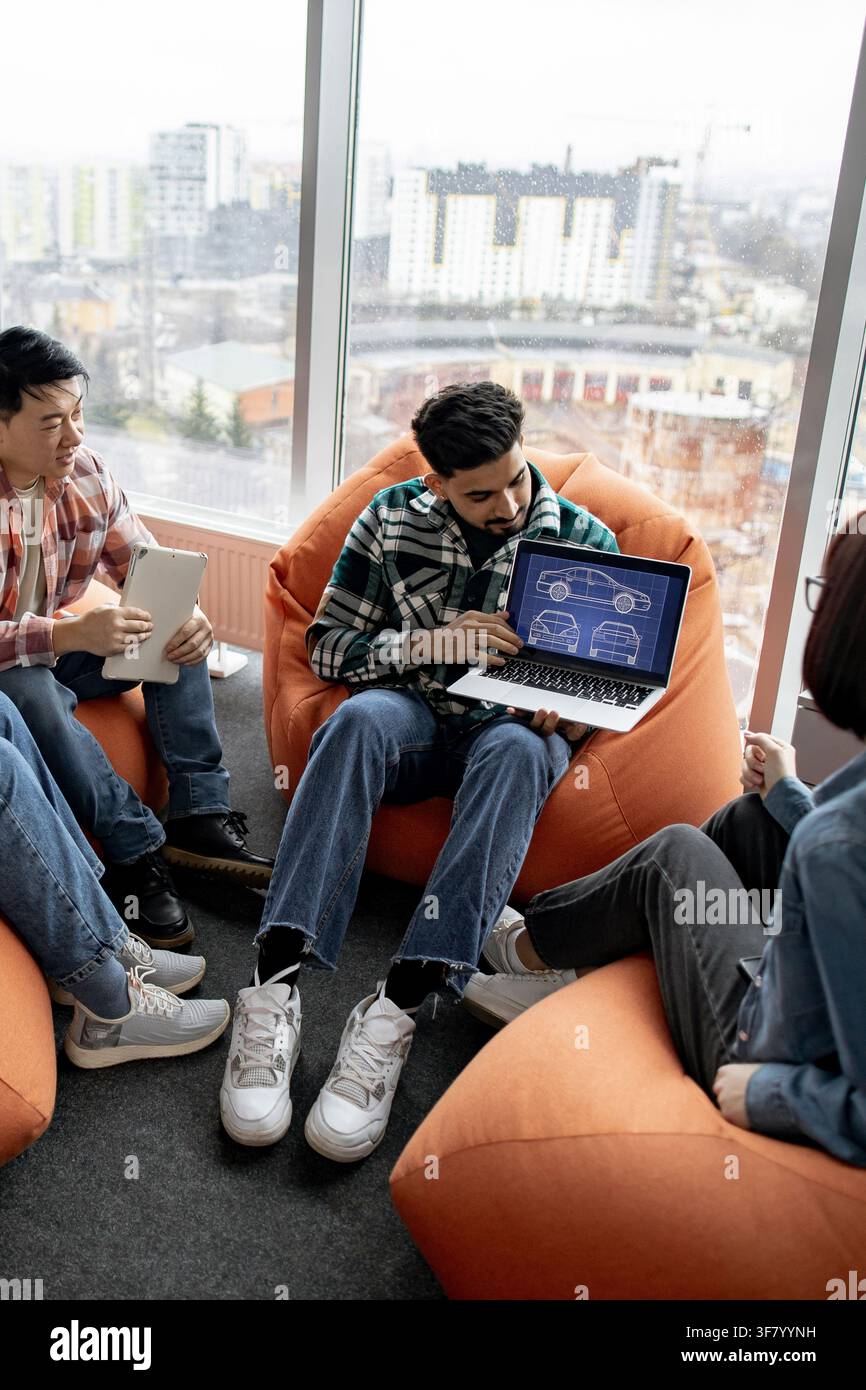 Team Discussing Car Design Blueprint Stock Photo