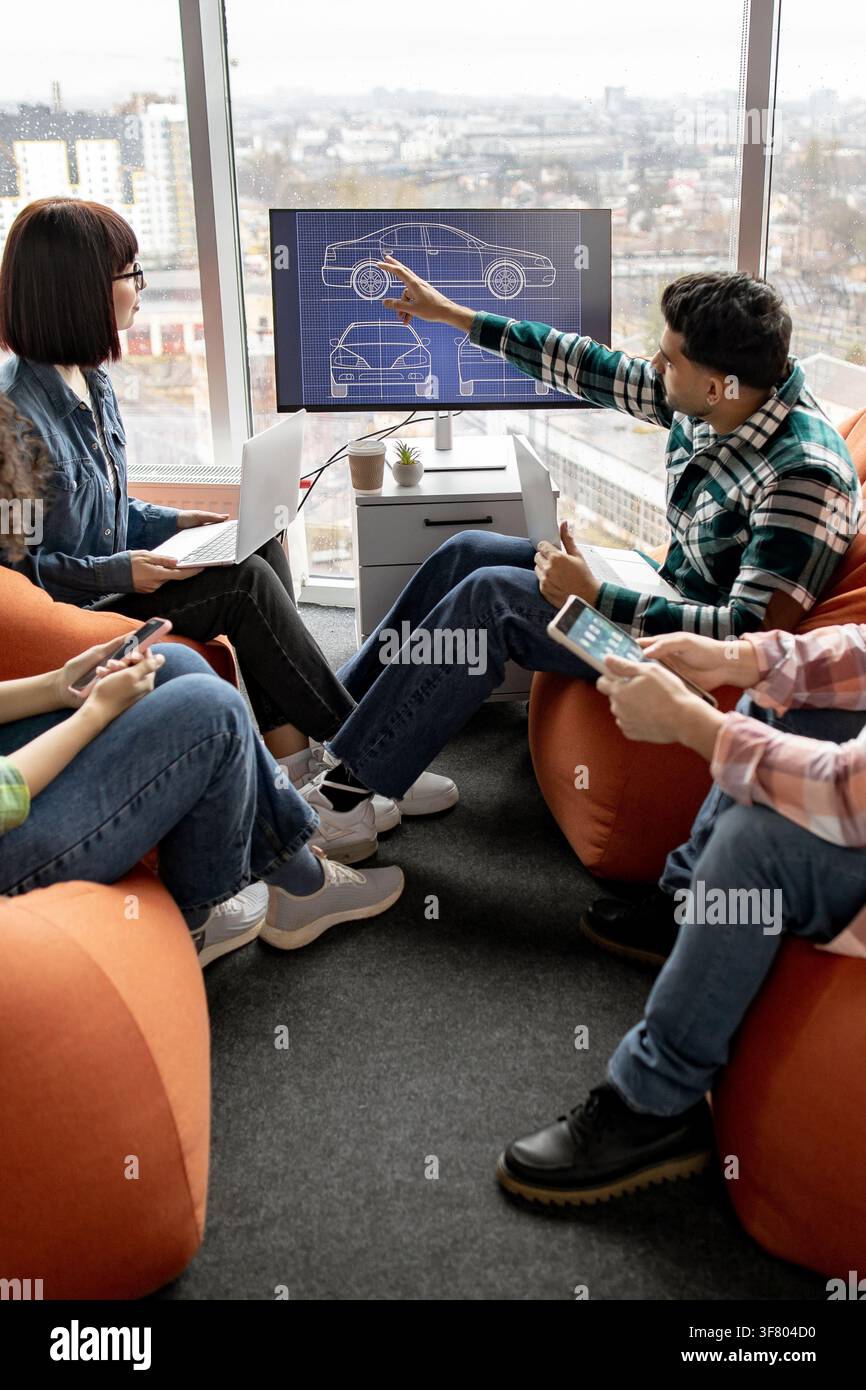 Team Discussing Car Design Blueprint Stock Photo