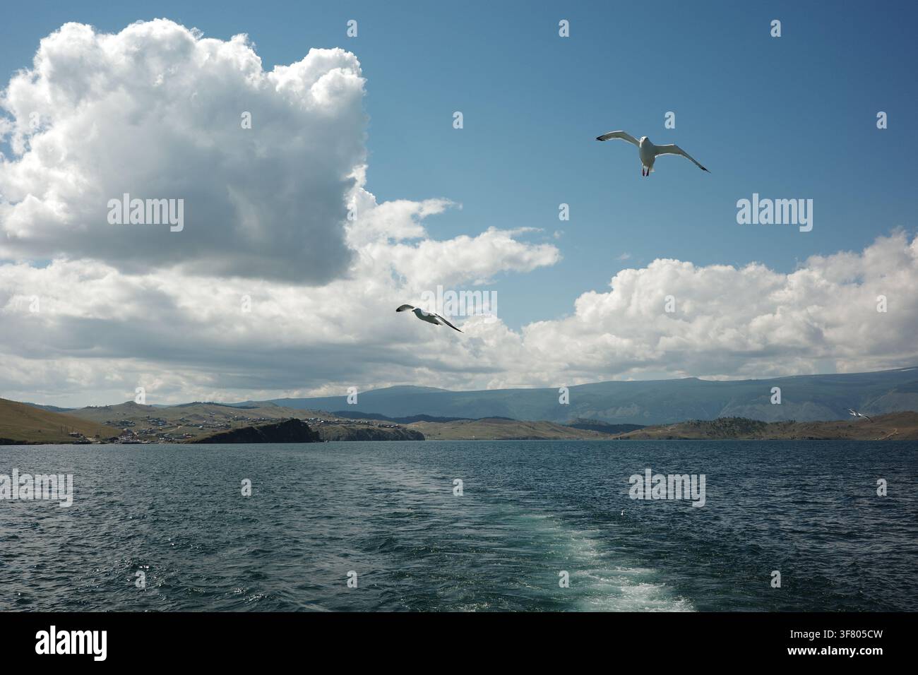 Two sons in the blue sky with clouds Stock Photo