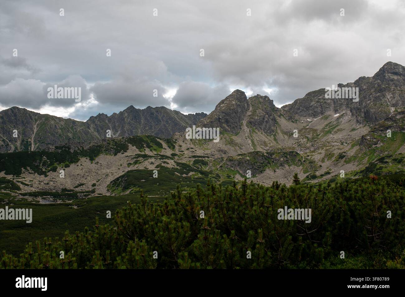 Rugged mountain range under a dramatic cloudy sky Stock Photo