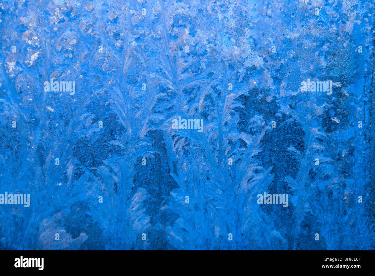 Frost pattern on a frozen window at winter. Natural background, texture Stock Photo